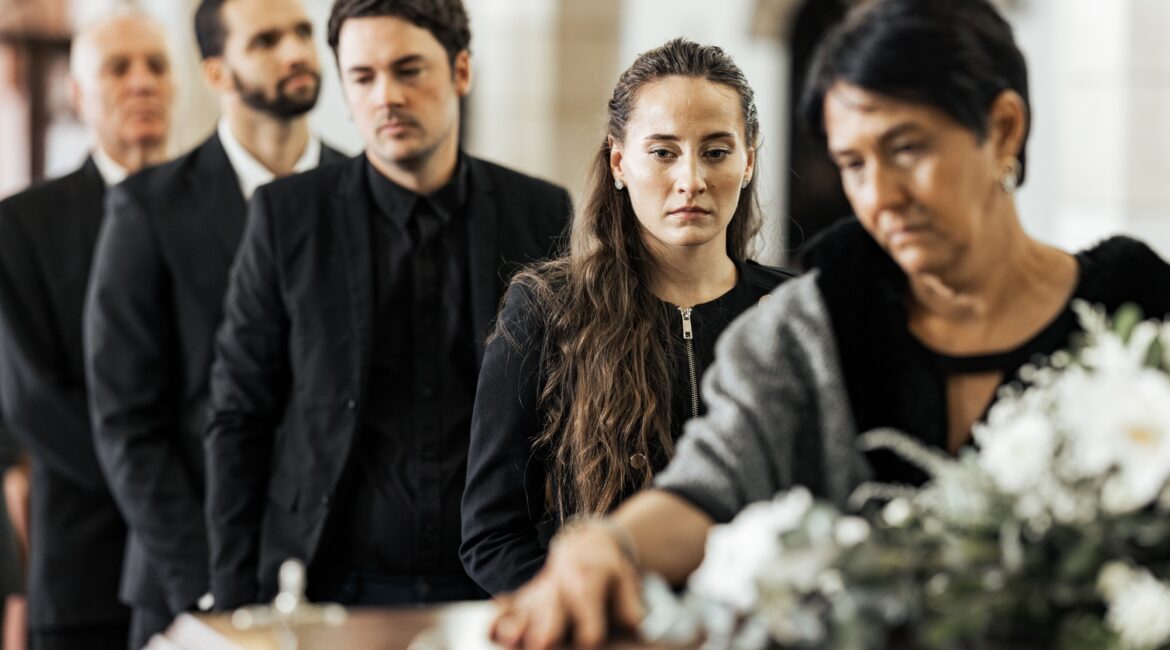 Funeral, goodbye and family with a coffin in a church during a service in death, mourning and grief